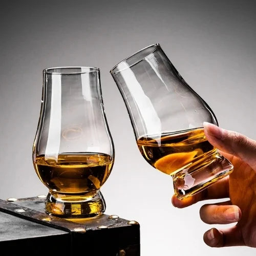 Deux verres à whisky qui trinquent, illustrant l’esprit convivial et chaleureux de vos soirées dégustation.